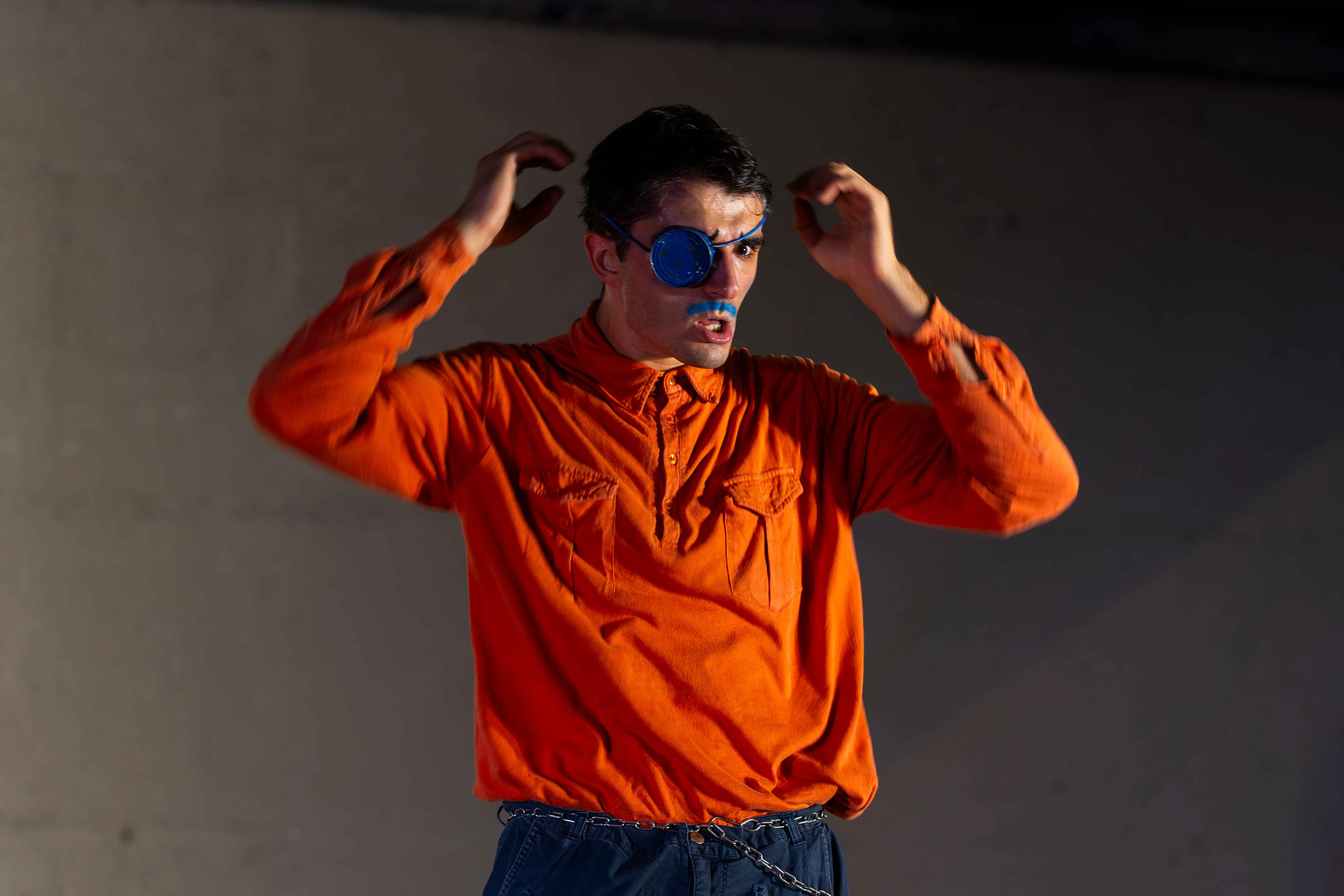 A pirate clown in an orange shirt.